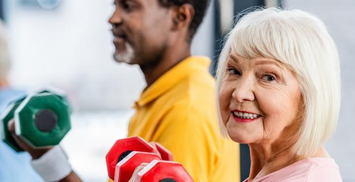 older people using weights in an exercise class